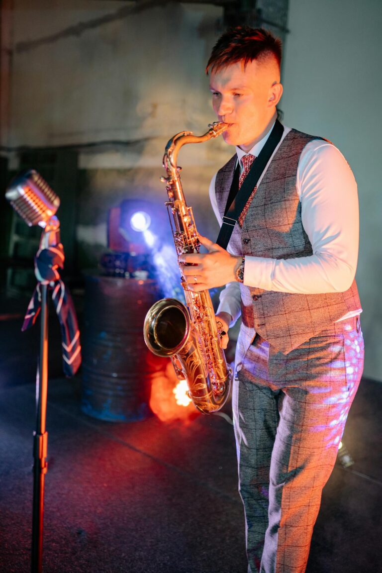A young saxophonist passionately playing on stage in a moody atmosphere with stage lights.